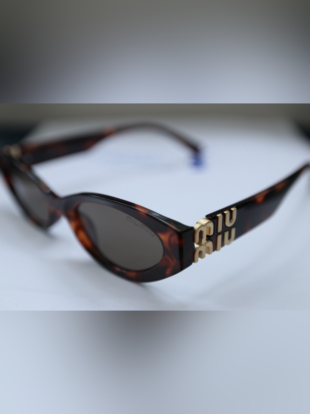 Miu Miu Tortoiseshell Sunglasses with Gold Logo Accent and Dark Lenses